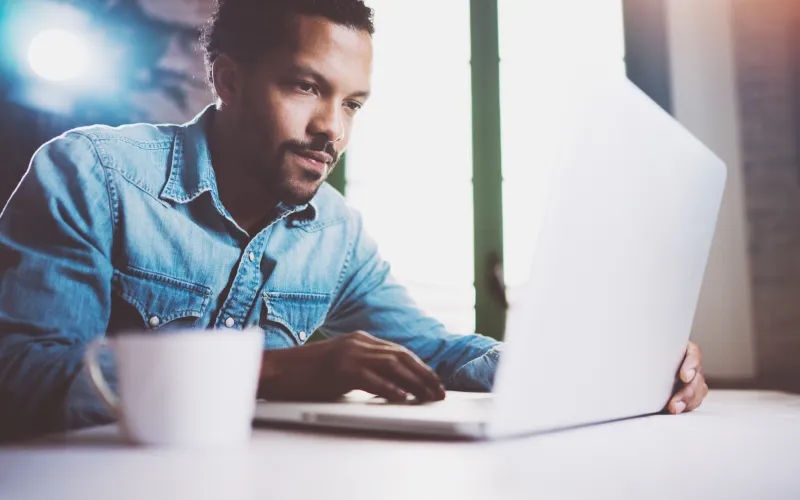 man with laptop and coffee