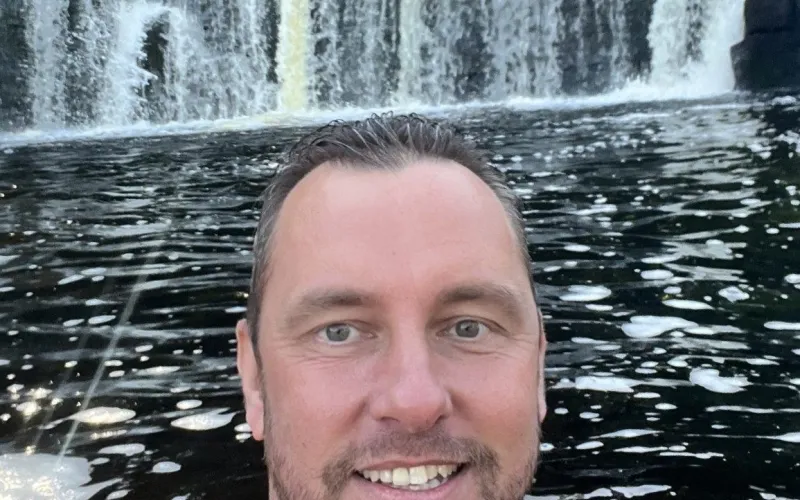 Danny Bankhead in water with waterfall behind
