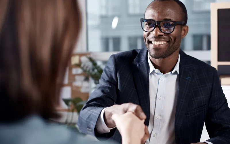 young man shaking hands with employer