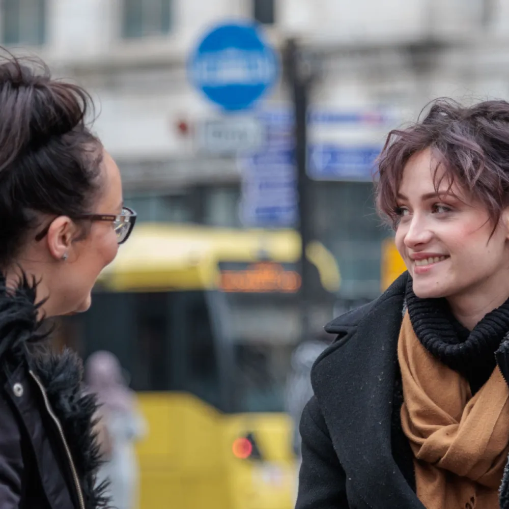 two women with bus in background