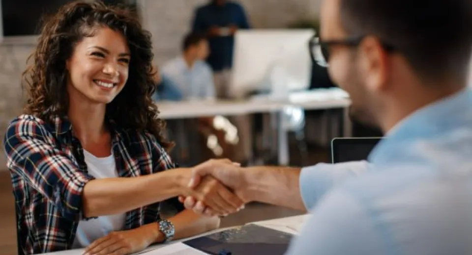 woman and man shaking hands