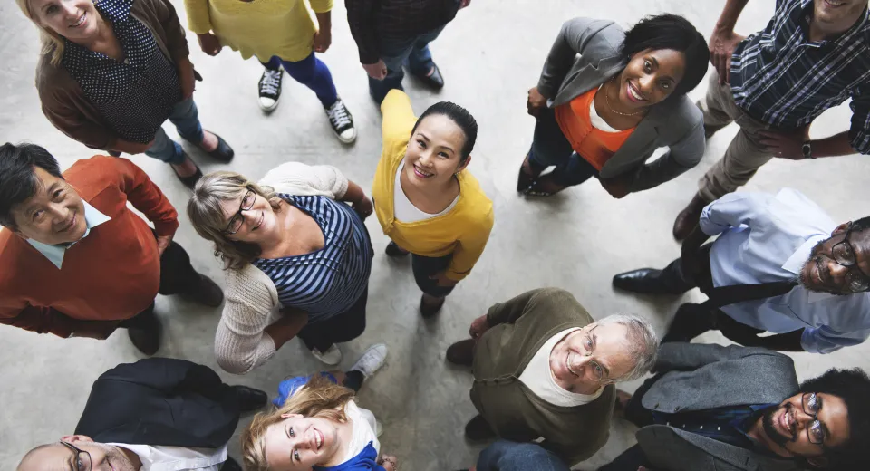 Diverse group of people looking up at the camera