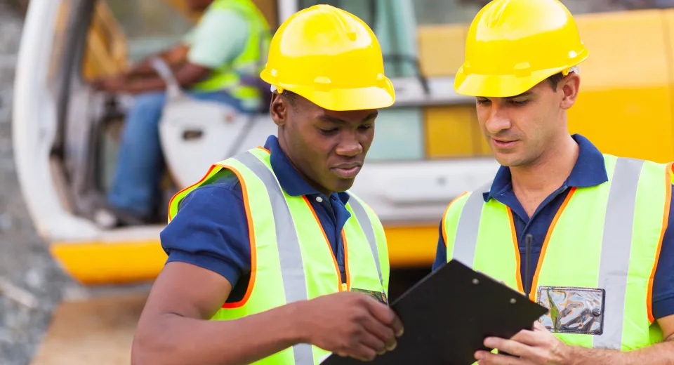 male workers with high vis and hard hats