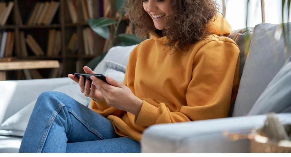 woman in hoody looking at phone